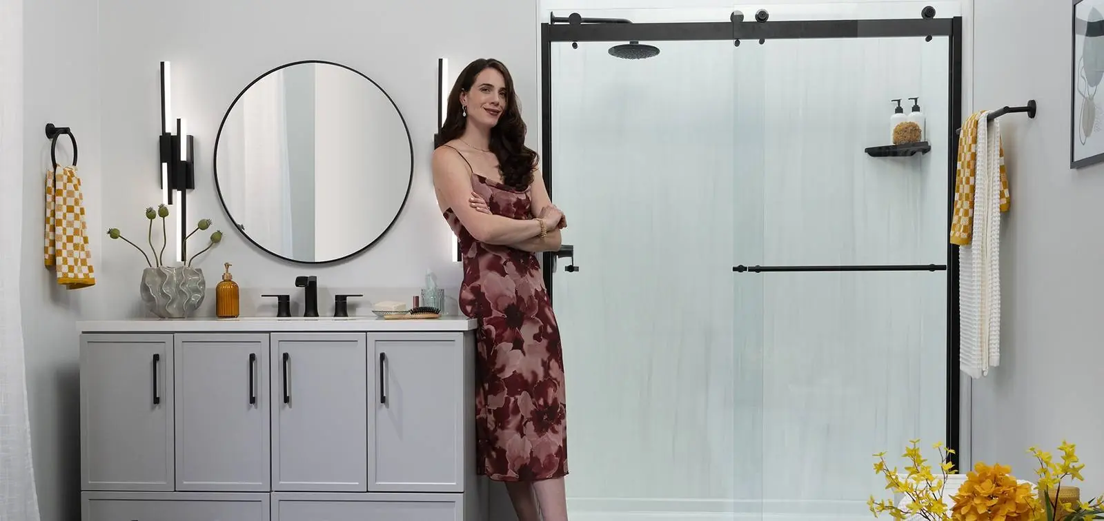 Homeowner beside a new Luxury Bath glass shower with a black frame