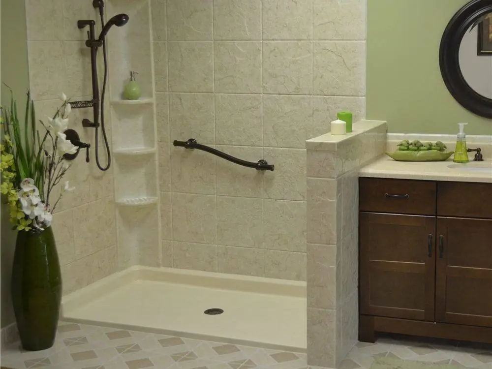 Walk-in shower with a built-in seat and a grab bar on a stone look wall
