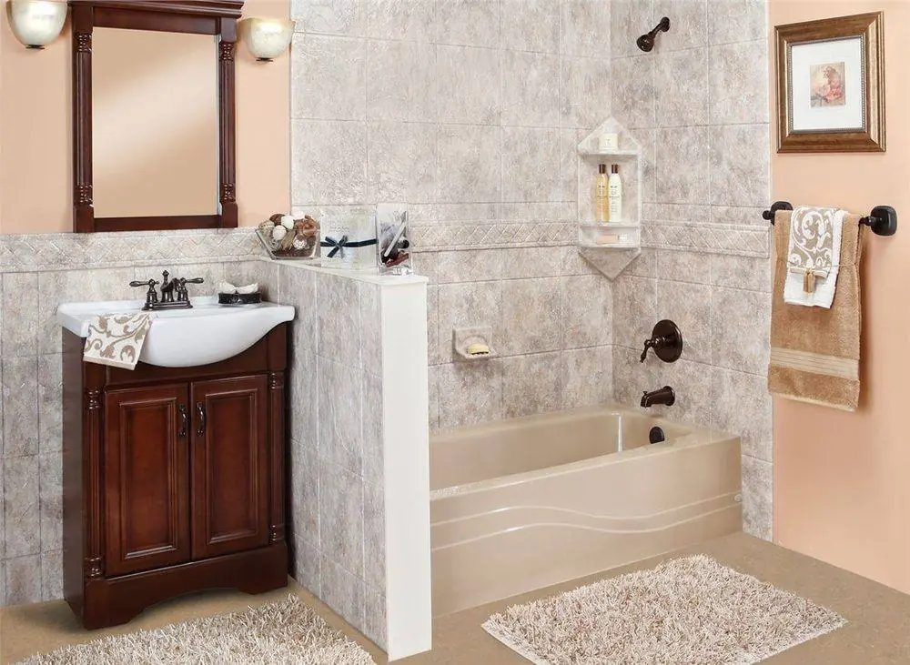 Almond bathtub with a gray stone look tub surround, a corner caddy and a cherry wood vanity