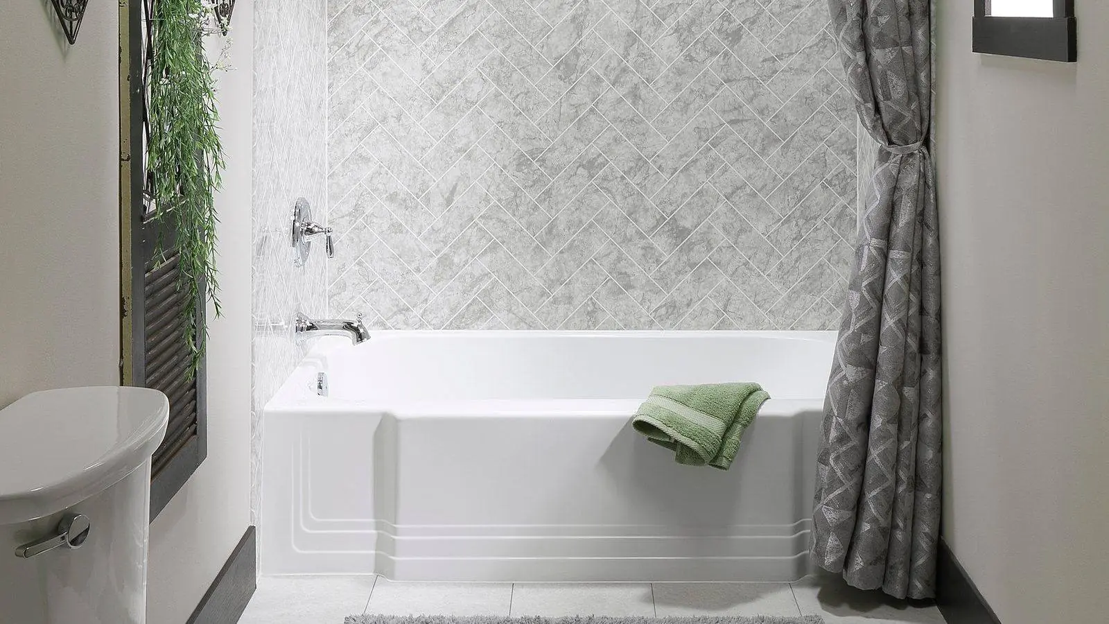 Luxury Bath tub and shower with a marble look surround and a glass door