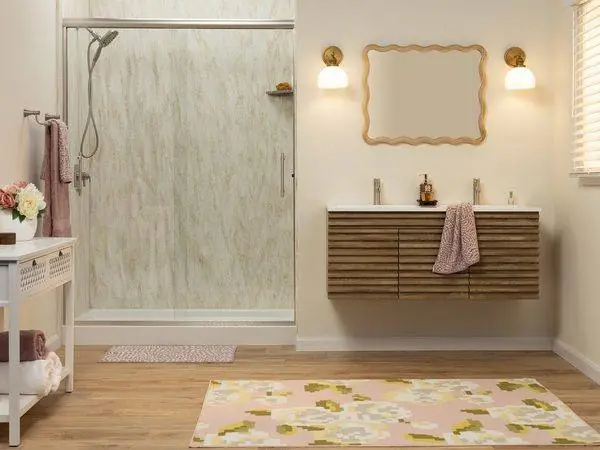 Finished walk-in shower with marble look walls and a walnut vanity
