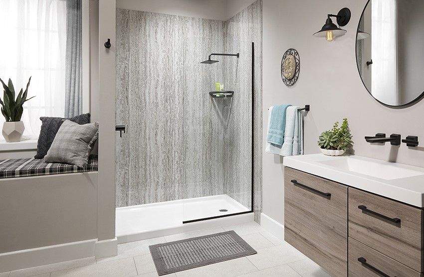 New walk in shower with marble look wall surround in a Spokane bathroom
