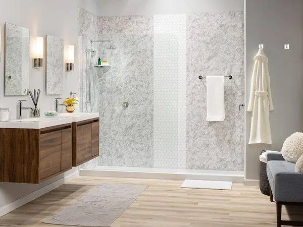 Walk-in shower with white marble look walls and brass fixtures
