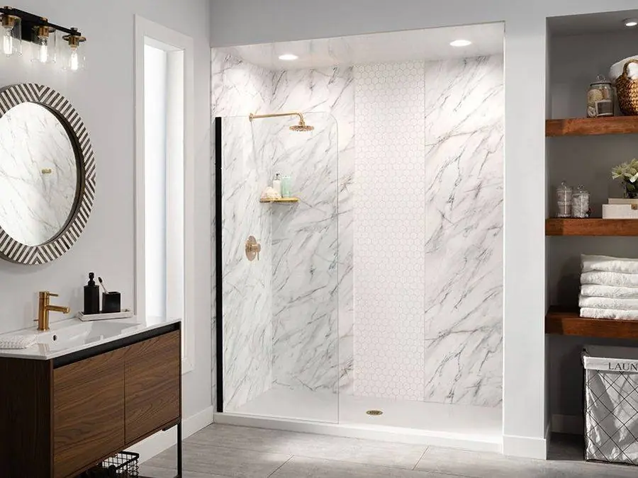 White marble look walk-in shower with brass fixtures and wood shelving
