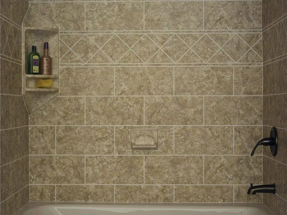Beige stone look wall surround with a diamond accent band, a corner shelf and a bronze faucet